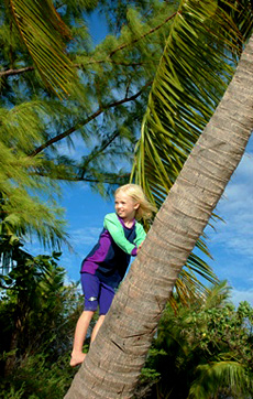 Mairen, 8, climbs a palm tree for a better look- Fakarava atoll, Tuamotus